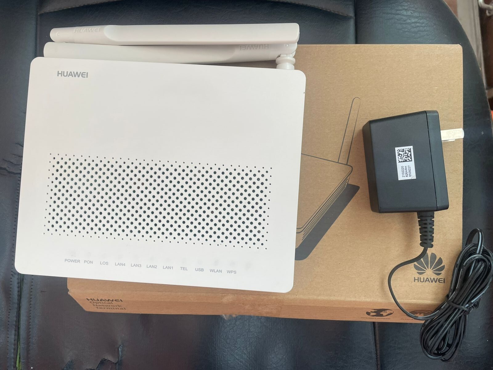 Huawei Dual Antenna GPON WiFi Router with Power Adapter – High-Speed Fiber Internet Modem 3 Top view of Huawei high-speed fiber optic WiFi router with ventilation design and indicator LEDs